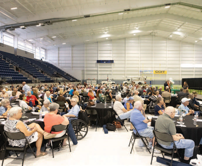members sitting in chairs at the annual meeting